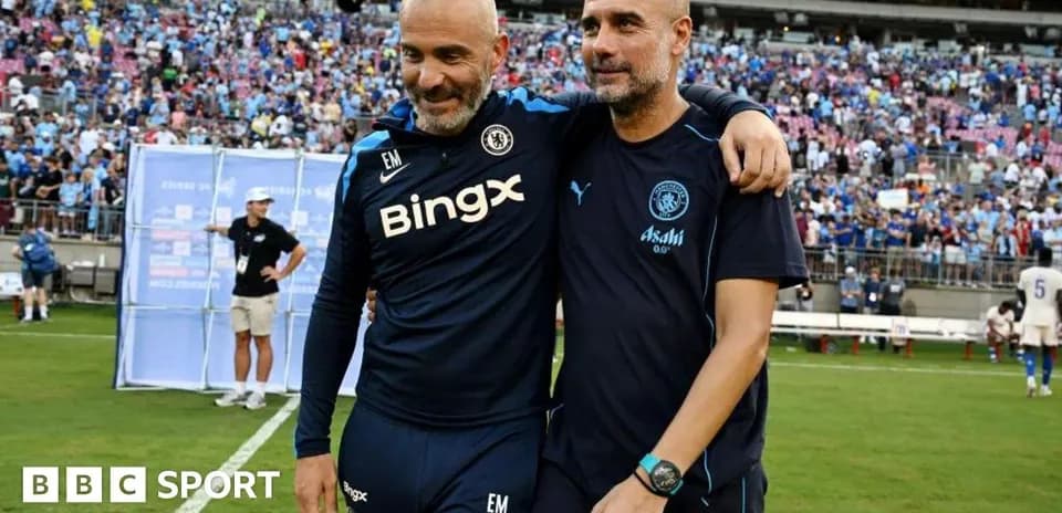 Entrenadores abrazándose en el campo de fútbol