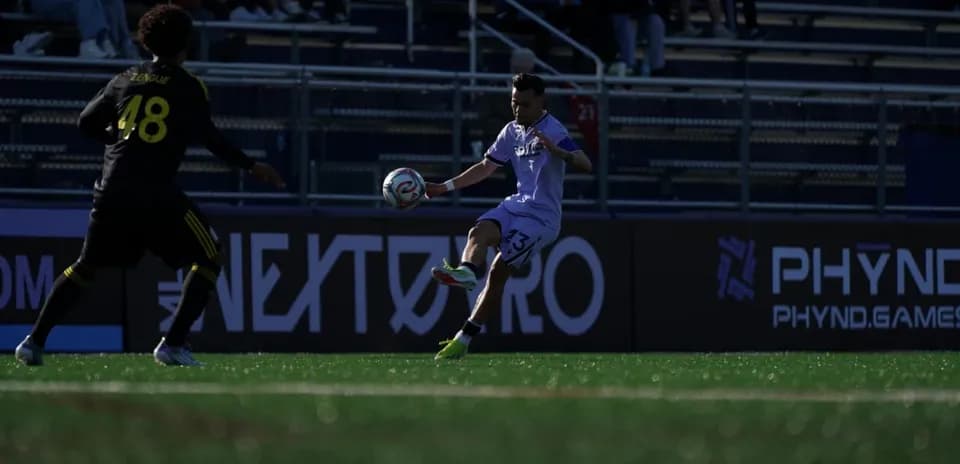 Jugador pasando el balón en un partido de fútbol