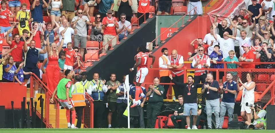 A player celebrating with fans in the stands