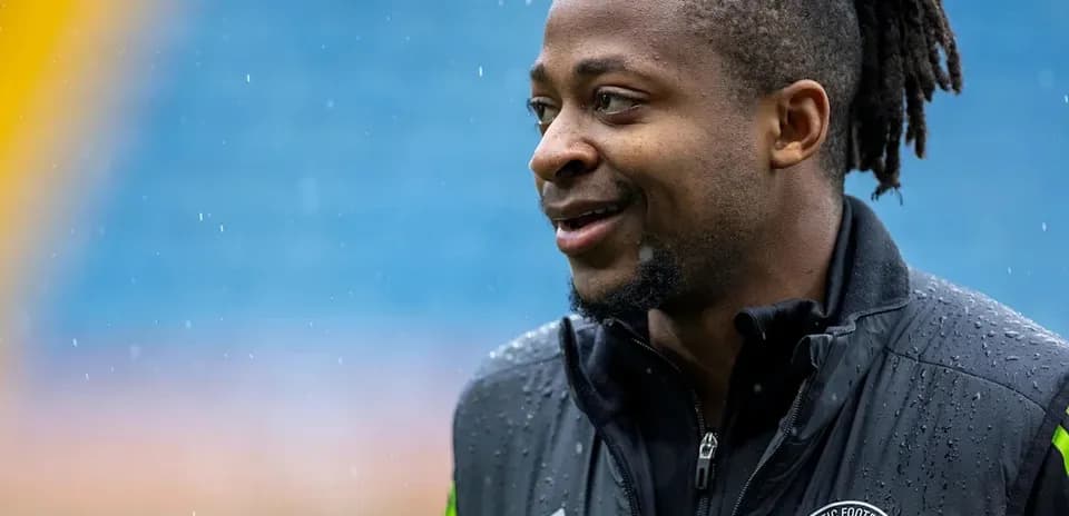 Jugador sonriente en la lluvia antes del partido