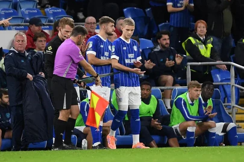 Jugador siendo sustituido en el banquillo del partido