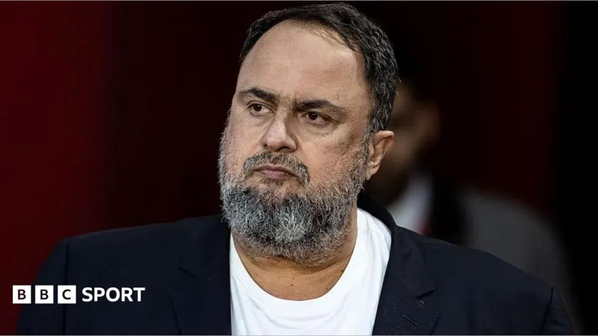 Hombre con barba y chaqueta oscura en conferencia
