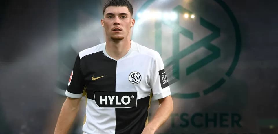 Jugador de fútbol con uniforme en fondo de estadio