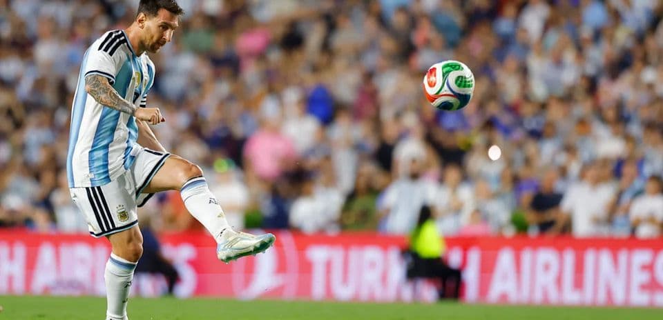 Lionel Messi kicking a soccer ball during match