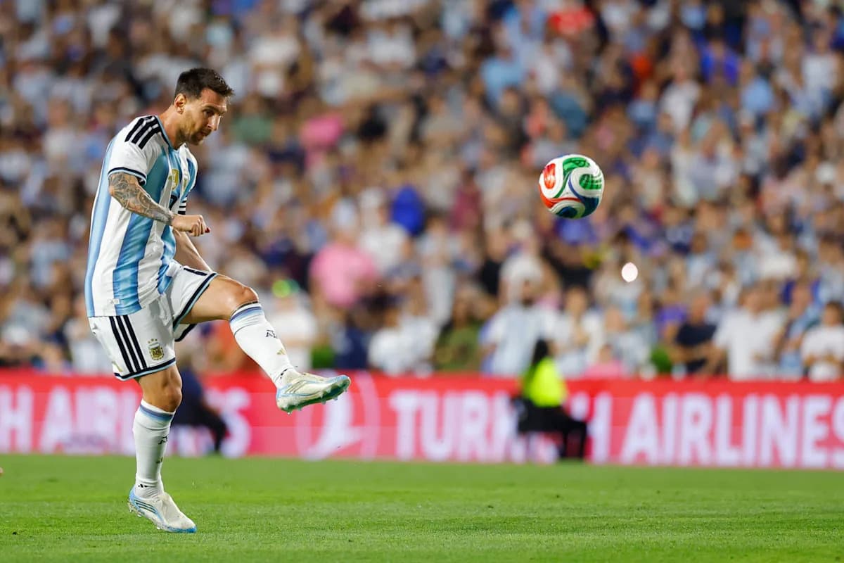 Lionel Messi kicking a soccer ball during match