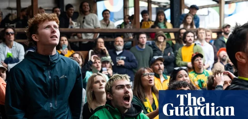 A crowd watching a sports event with intense expressions