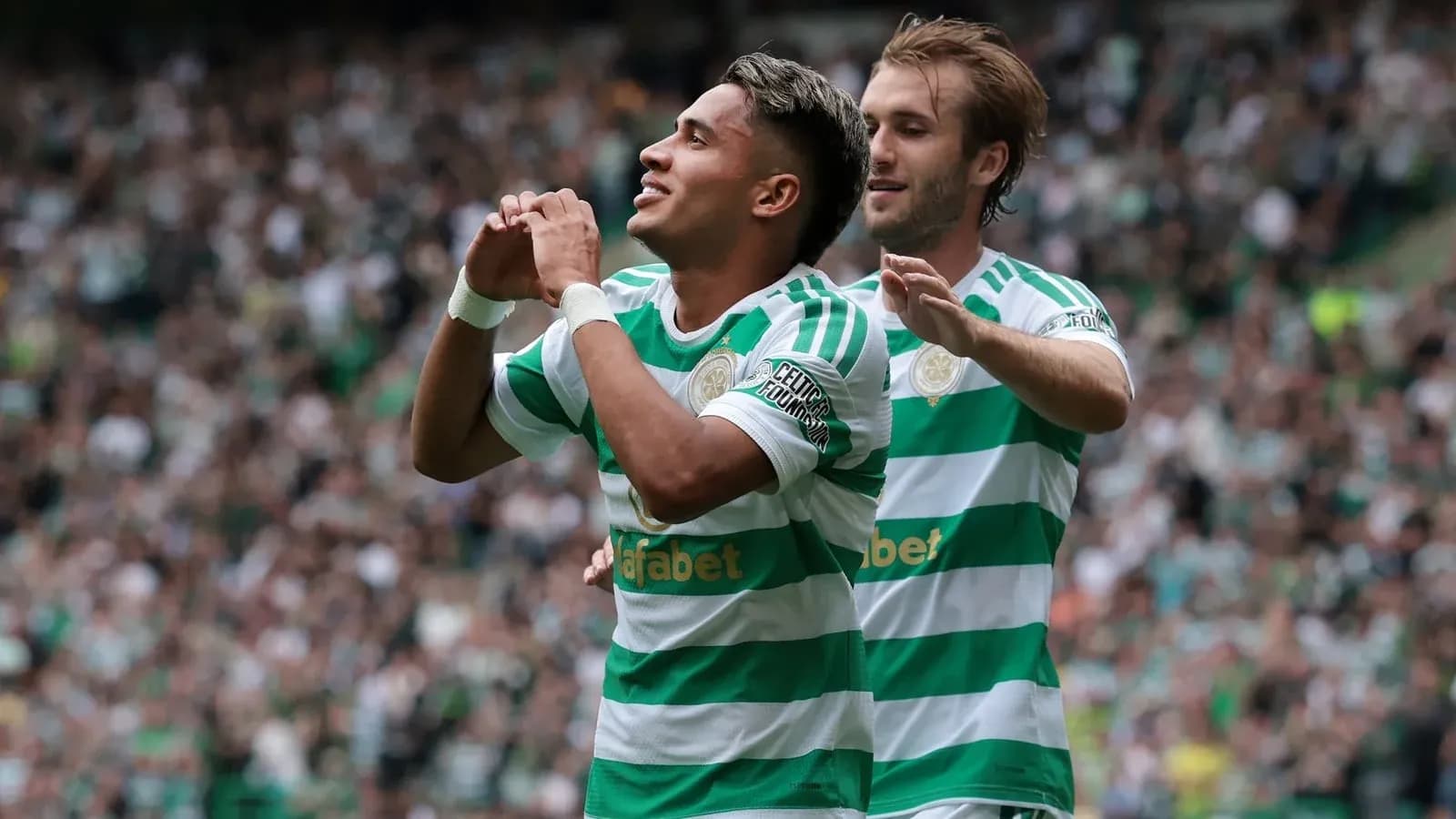 Jugador de Celtic celebrando un gol con compañero