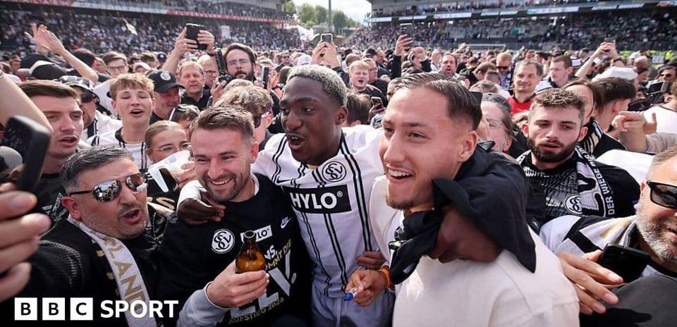 Agroup celebrating in crowd after match victory