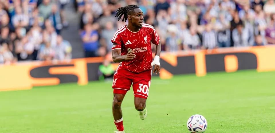 Jugador de Liverpool corriendo tras el balón en el campo