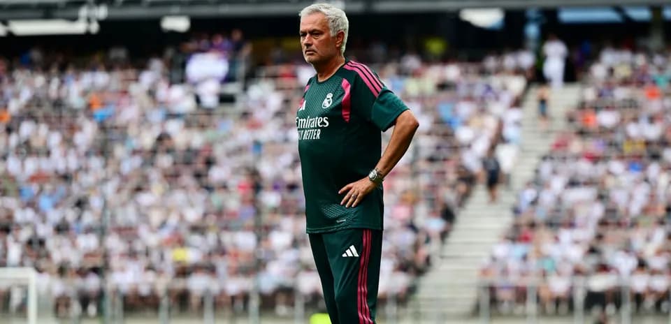 Entrenador de pie en la línea de banda durante partido