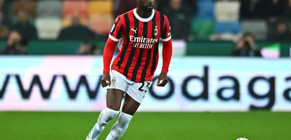 Jugador de AC Milan corriendo tras el balón en el campo