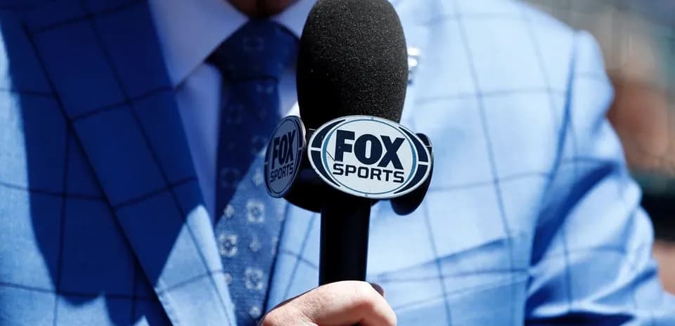 Mic with FOX Sports logo held by reporter