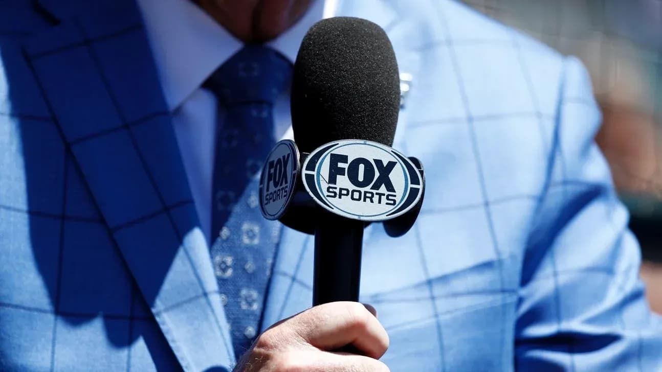 Mic with FOX Sports logo held by reporter
