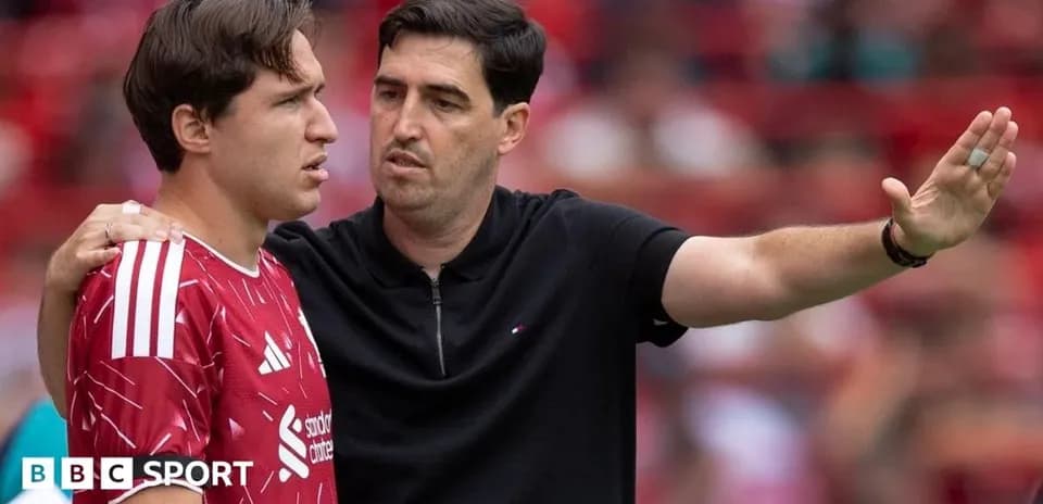Entrenador dando instrucciones a jugador en el campo
