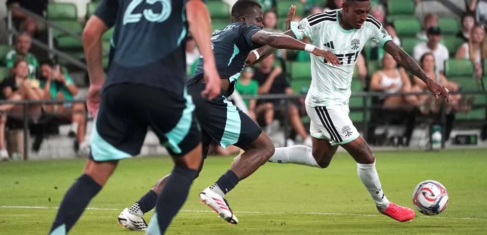 Jugador corriendo con el balón en el campo