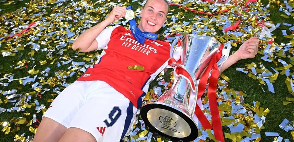 Jugadora de Arsenal con trofeo y medalla de campeona