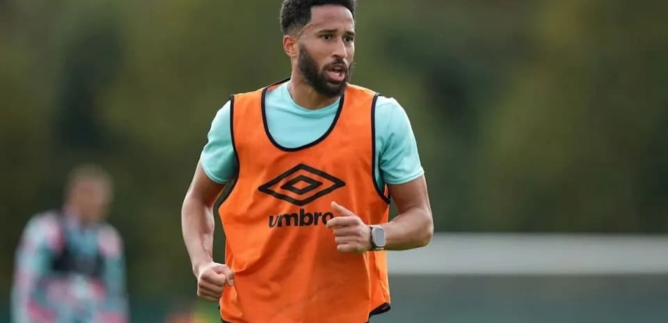 Jugador entrenando con pechera naranja en campo