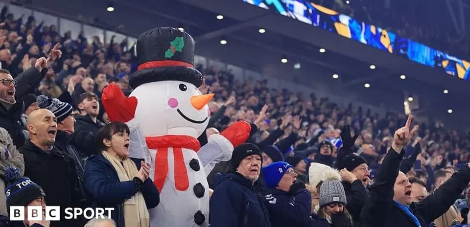 A giant snowman among cheering football fans