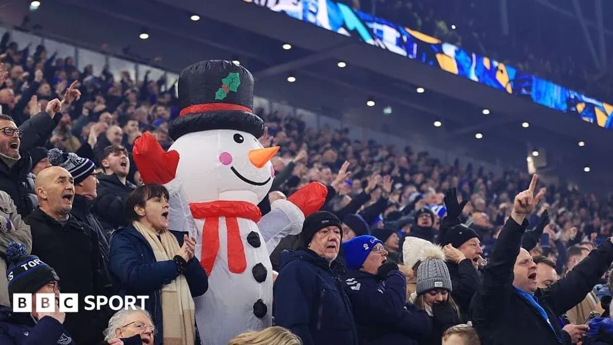 A giant snowman among cheering football fans