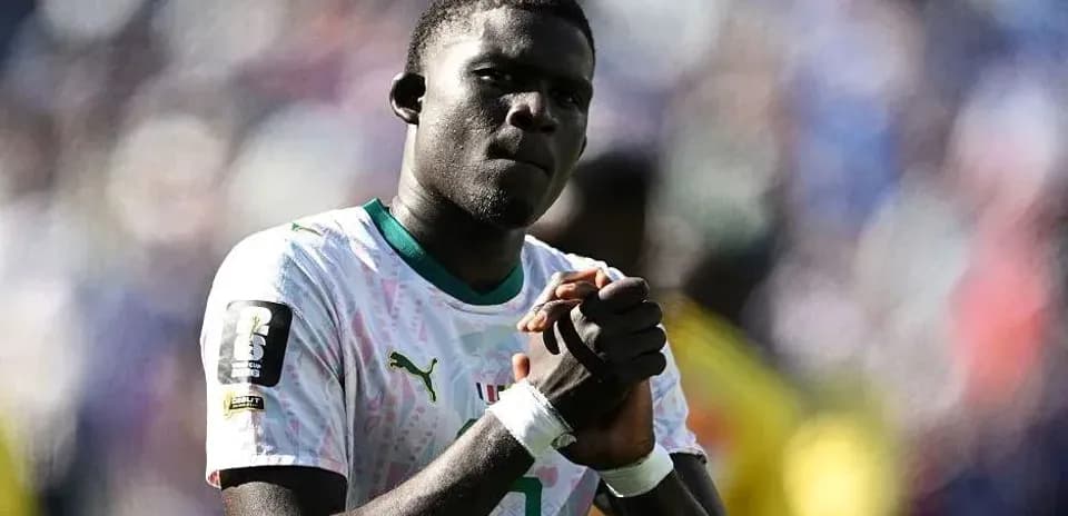 Jugador de fútbol con uniforme de Senegal en el campo
