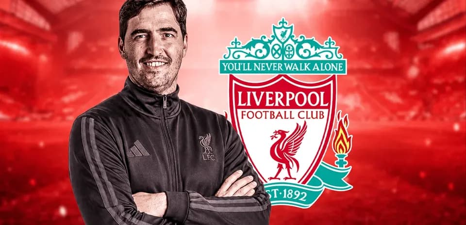 Entrenador de Liverpool junto al escudo del club
