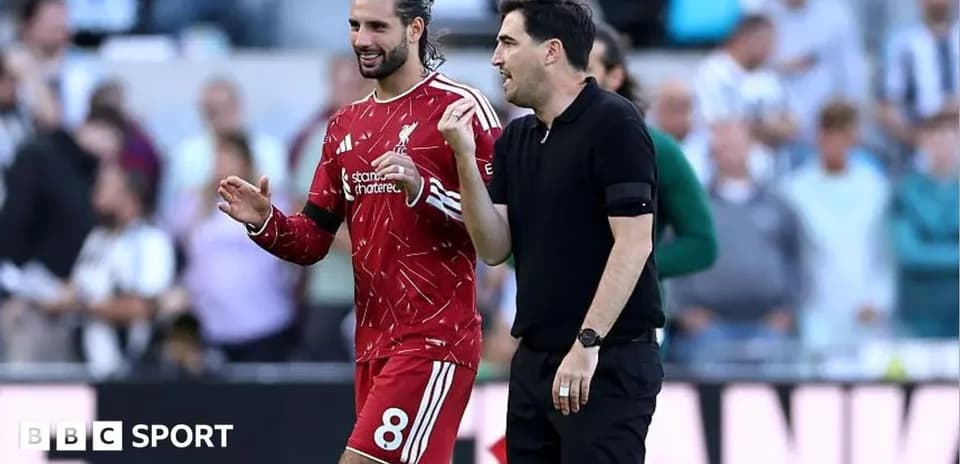 Jugador y entrenador conversando en el campo