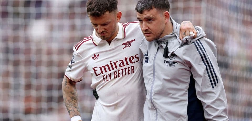 Jugador de Arsenal siendo ayudado por el personal médico
