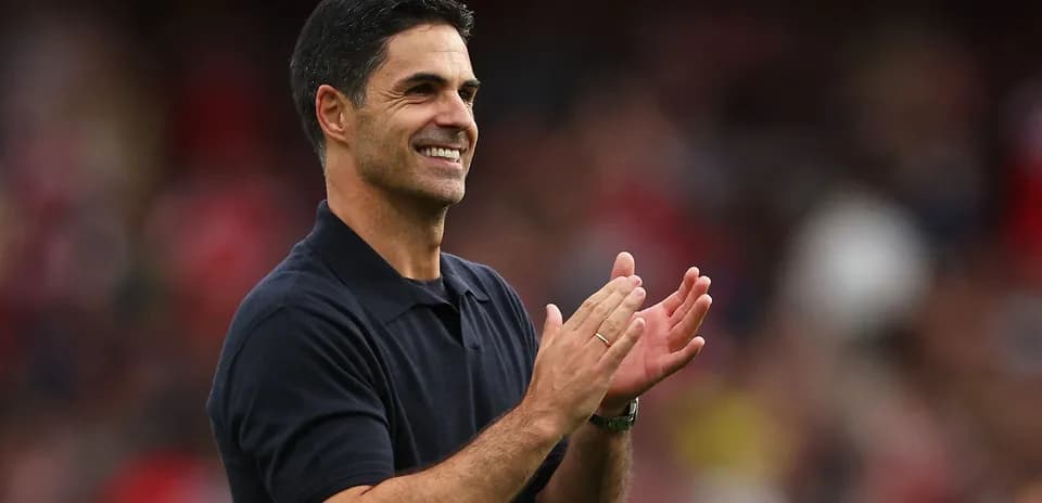 Entrenador aplaudiendo en el banquillo durante el partido