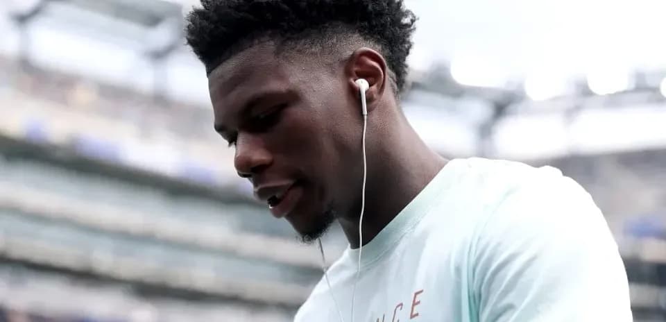 Jugador con auriculares en el estadio antes del partido