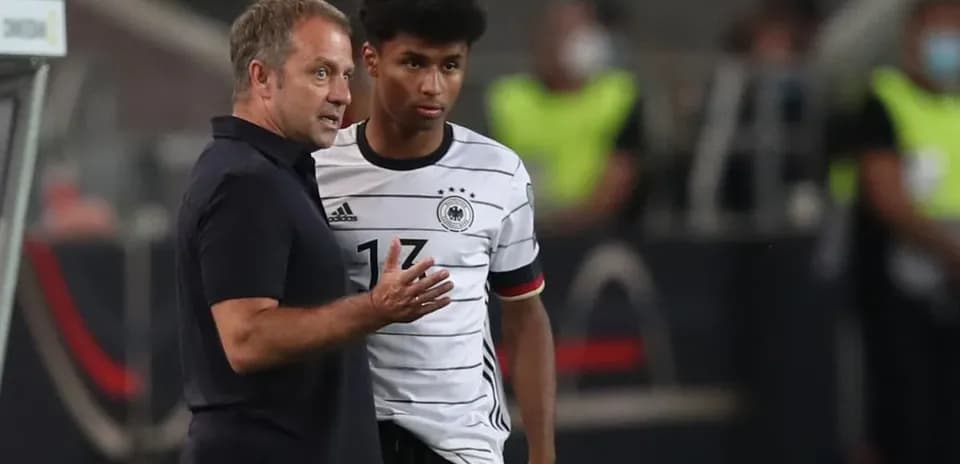 Entrenador hablando con jugador de Alemania en partido