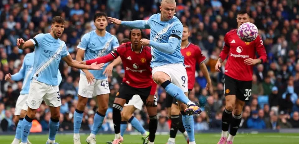 Erling Haaland kicking ball during Manchester derby