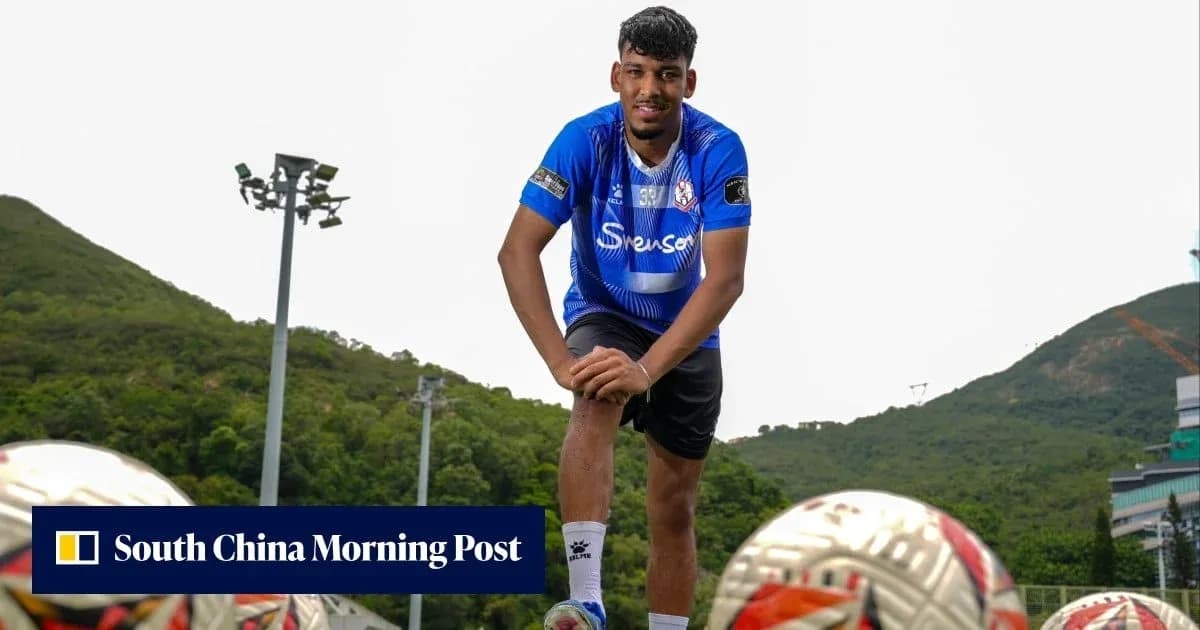 Jugador de fútbol posando con balones en campo