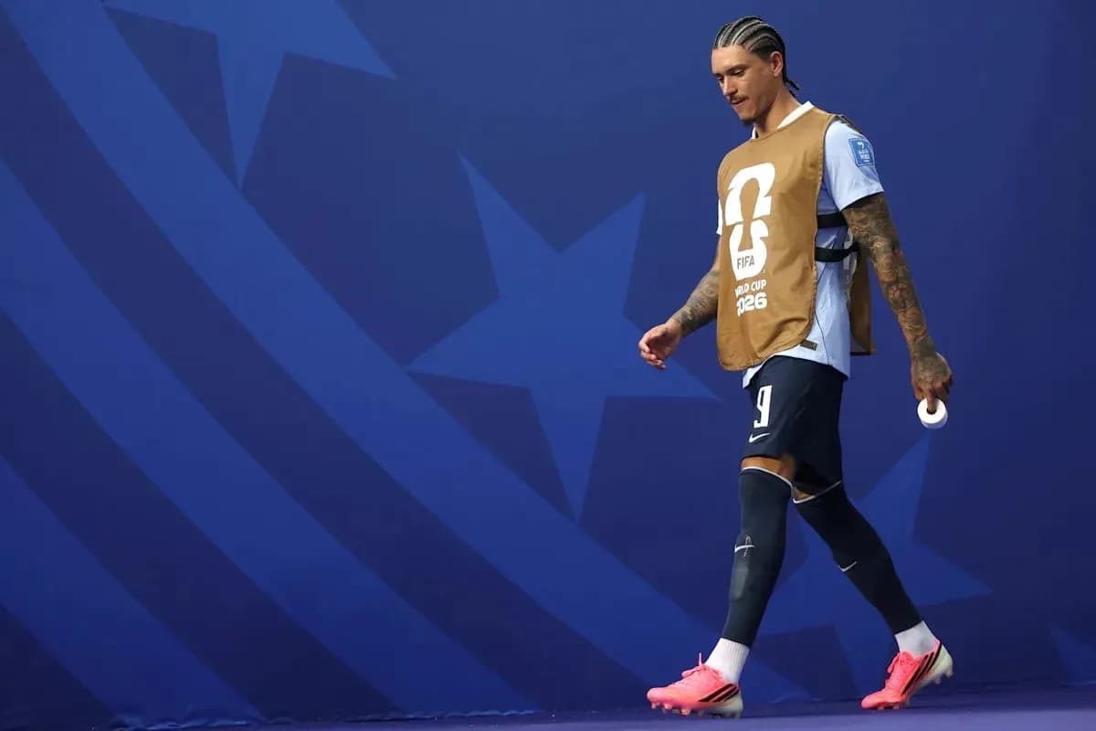 Jugador saliendo al campo con pechera de entrenamiento