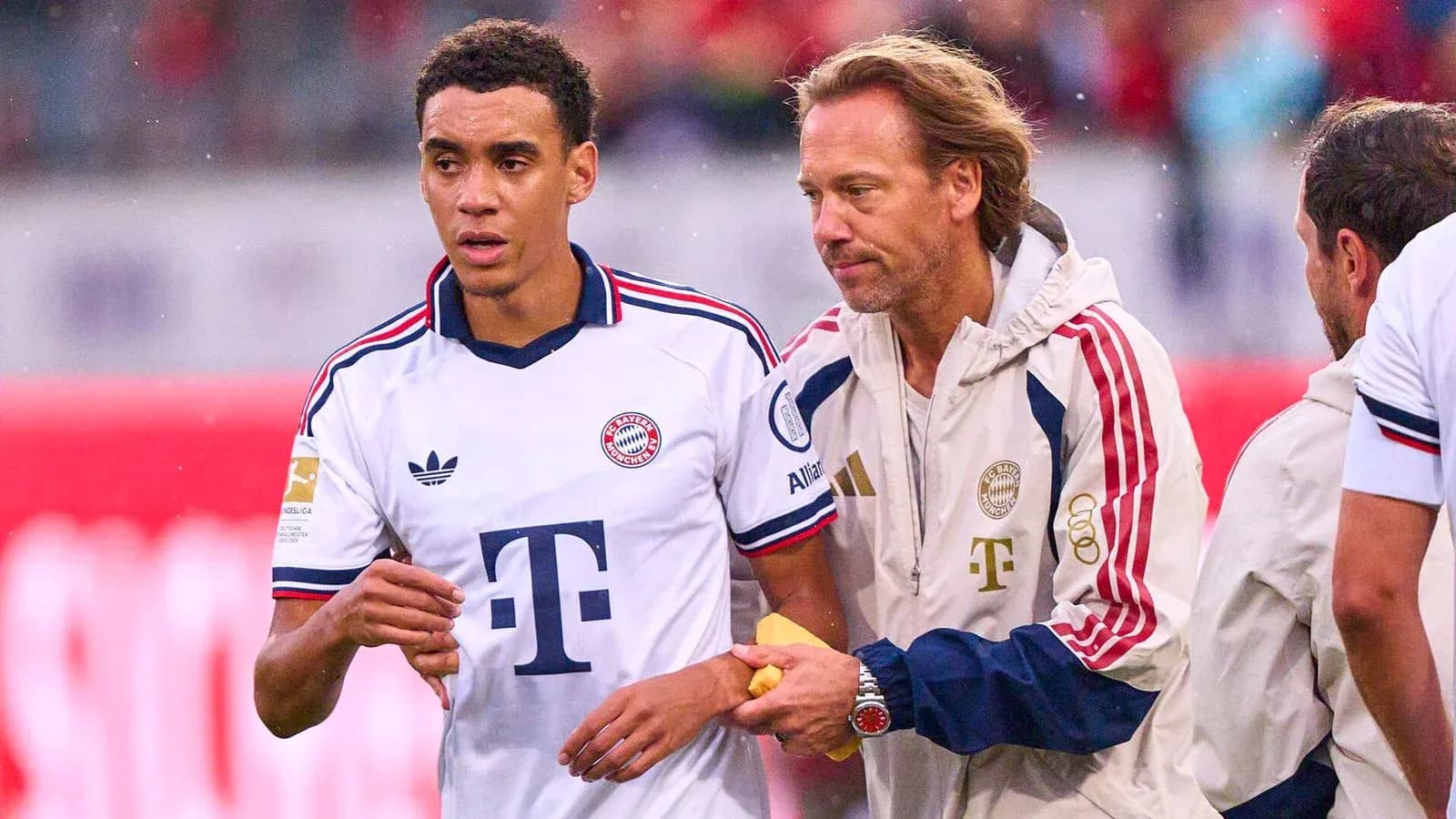 Jugador de Bayern Munich siendo asistido por el entrenador