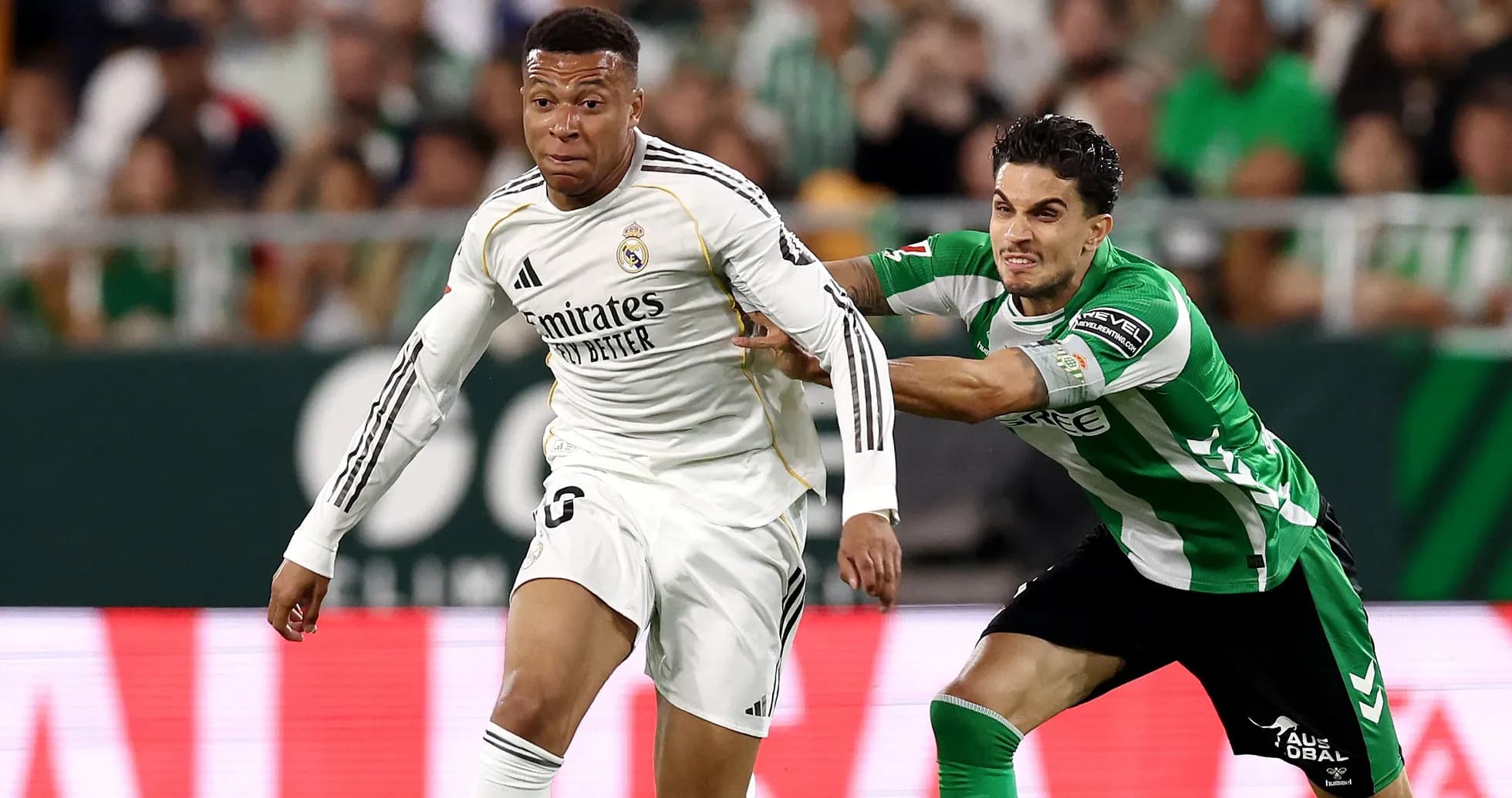 Mbappé dribbling while being challenged by defender Mbappé dribbling while being challenged by defender