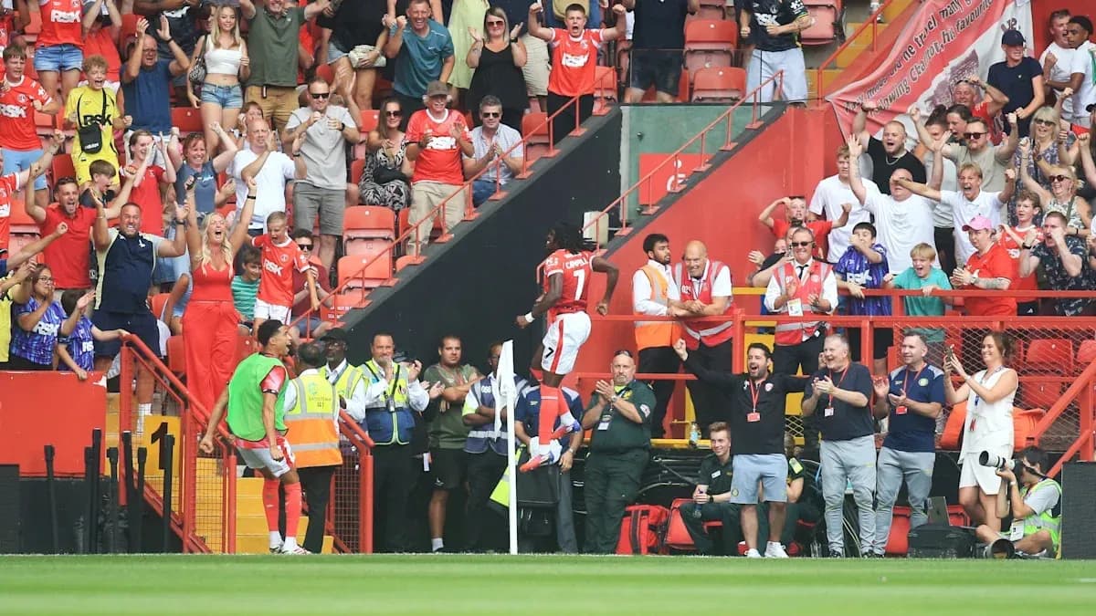 A player celebrating with fans in the stands A player celebrating with fans in the stands