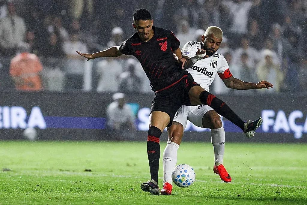 Jugador de Athletico Paranaense desafiando a rival de Santos Jugador de Athletico Paranaense desafiando a rival de Santos