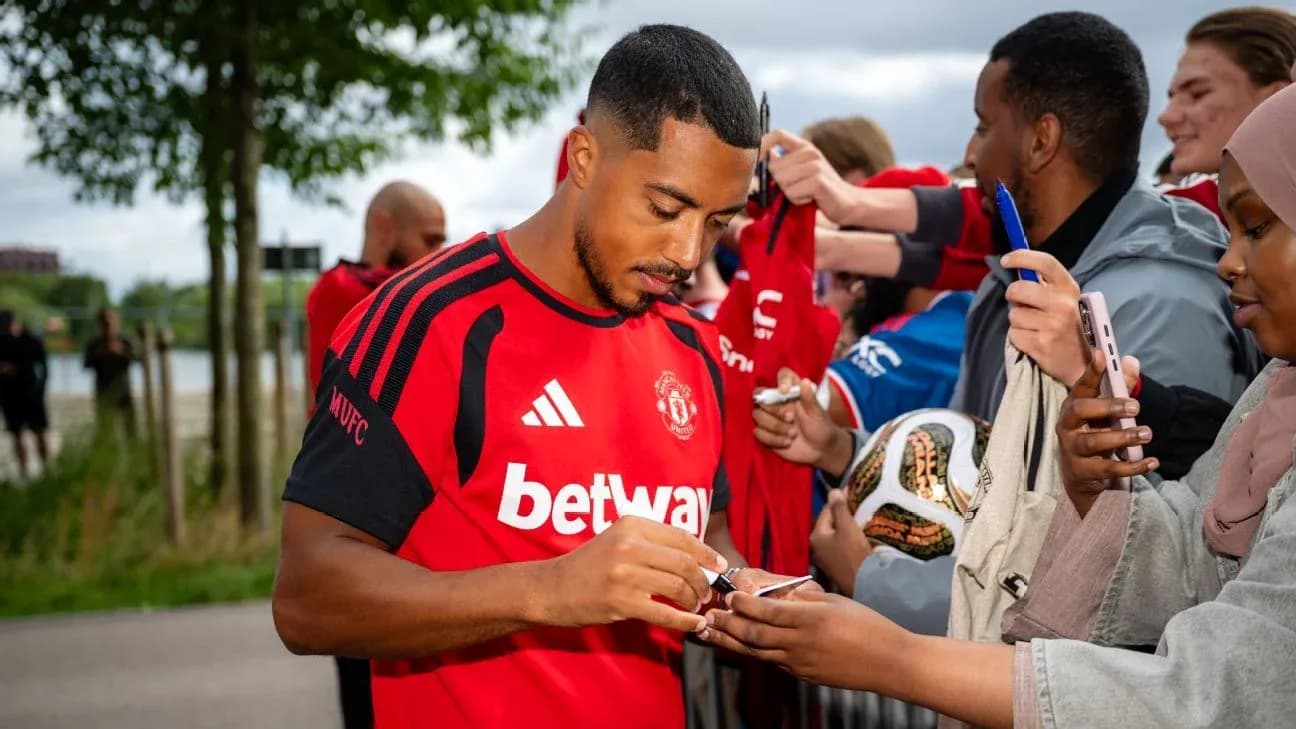 Jugador de Manchester United firmando autógrafos a fans Jugador de Manchester United firmando autógrafos a fans