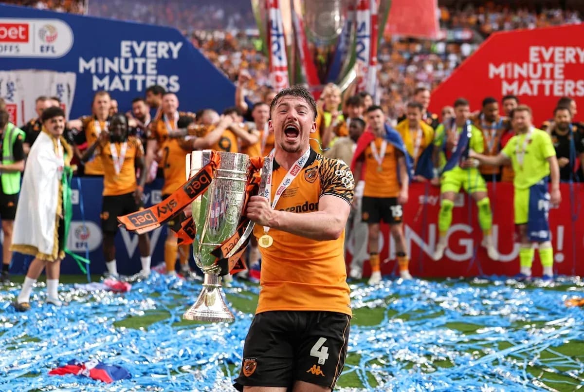 Jugador de Hull City celebrando con trofeo en el campo Jugador de Hull City celebrando con trofeo en el campo