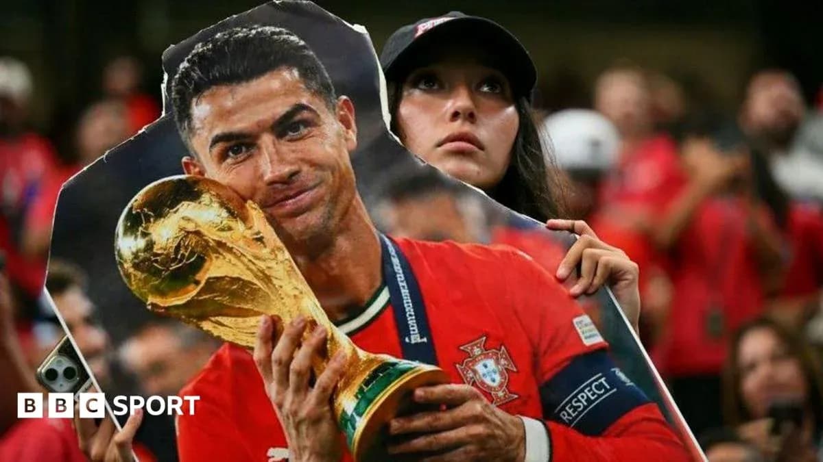 A fan holding a cutout of Cristiano Ronaldo A fan holding a cutout of Cristiano Ronaldo