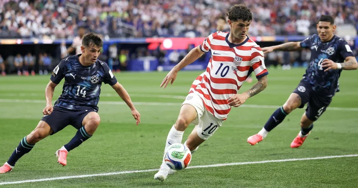 Christian Pulisic dribbling past two defenders during match Christian Pulisic dribbling past two defenders during match