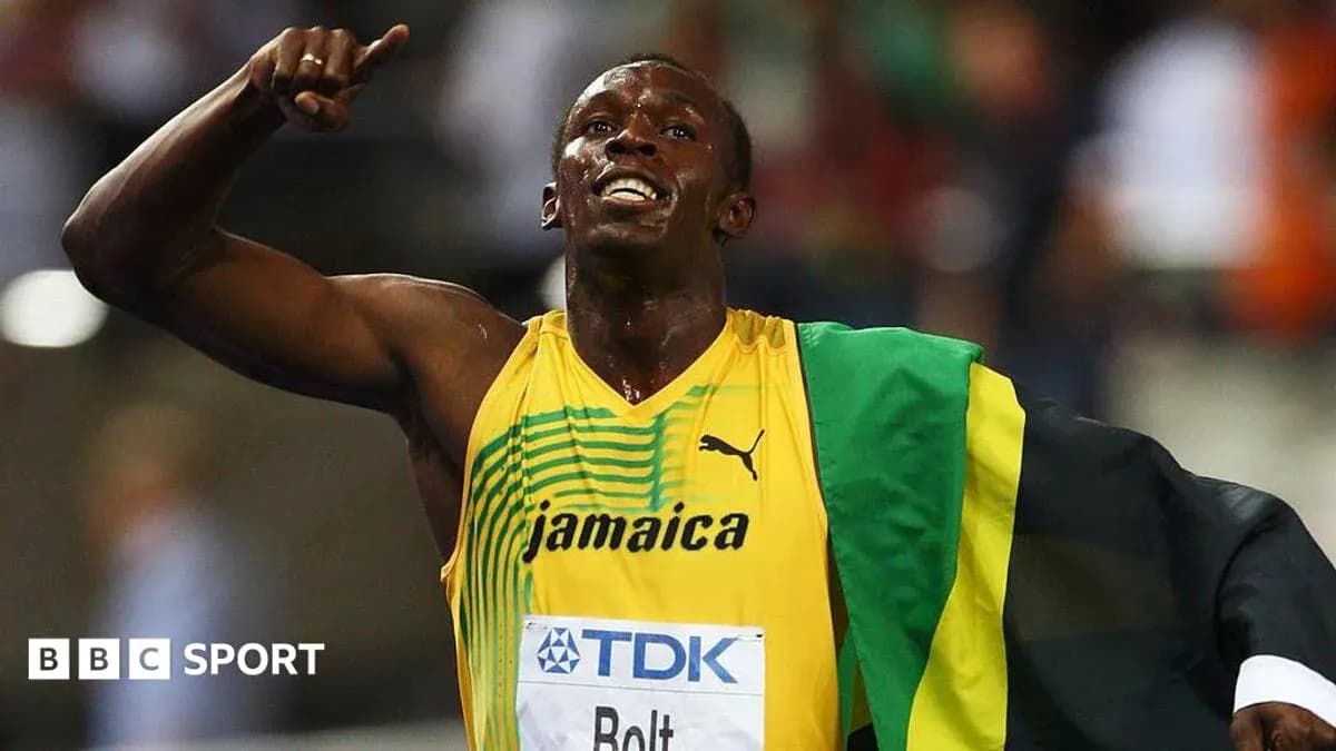 Atleta celebrando en pista con bandera de Jamaica Atleta celebrando en pista con bandera de Jamaica
